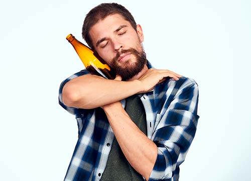 Мужчина обнимает бутылку